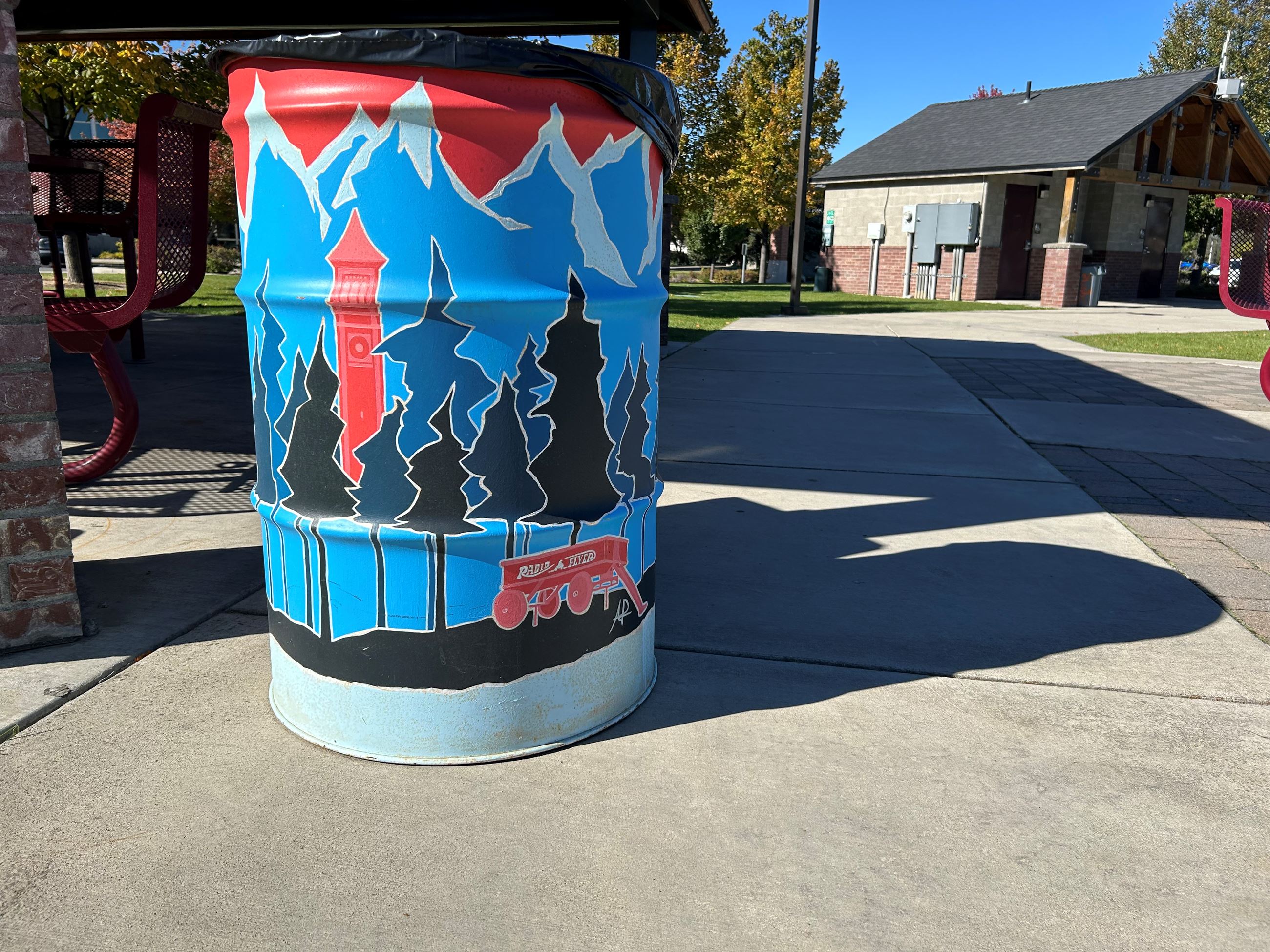 Image of 50 gal metal can with Spokane monument art painted on it.